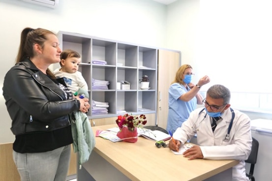 Patients and health personnel at the newly reconstructed health centre in Ishëm, Albania.