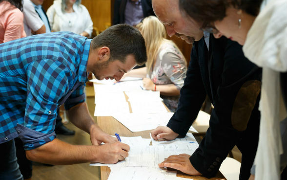 Image of a ceremony of distributing certificates for local community and municipal representatives