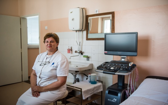 A nurse sitting in a treatment room.