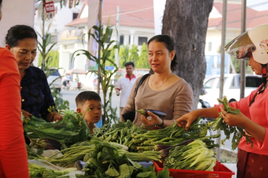 Families at a local produce shop in Phnom Penh, Cambodia.