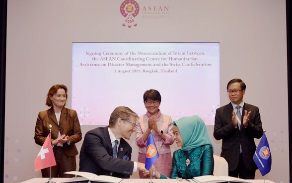 Switzerland’s State Secretary Pascale Baeriswyl (left), Thailand’s Permanent Secretary Busaya Mathelin (middle) and ASEAN Deputy Secretary General Hoang Anh Tuan (right) witnessing the signing of a Memorandum of Intent between Switzerland and the ASEAN Coordinating Centre for Humanitarian Assistance on Disaster Management (AHA Centre).
