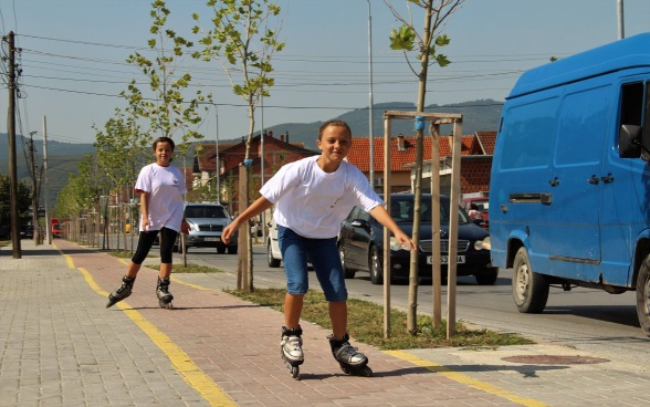 Due giovani con i rollerblade  su una pista ciclabile.