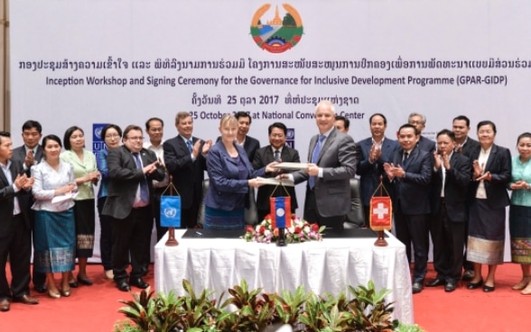 Mr. Tim Enderlin, Regional Director of the Swiss Agency for Development and Cooperation, Mme. Kaarina Immonen, UNDP Resident Representative sign the GPAR-GIDP agreement.