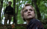 Main actress looking around in the forest