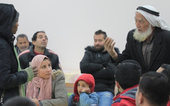 Lively debate between members of a community about future projects for their village as part of an SDC engagement in Gaza.