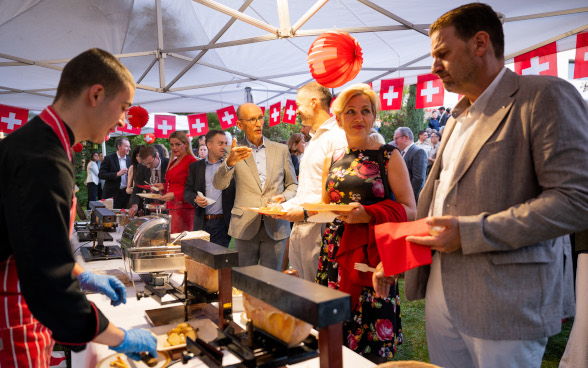 Raclette serving at  the Swiss National Day 2024 reception