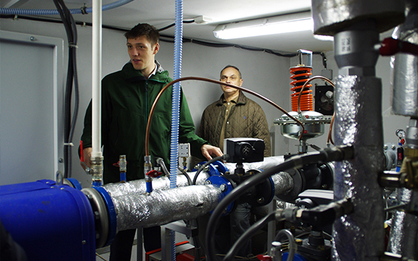 The SECO team inspects an individual heating unit in Zhytomyr.