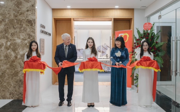 Swiss Ambassador and Dr. Lan Dung cut the ribbon inaugurating the Geneva Conference Room