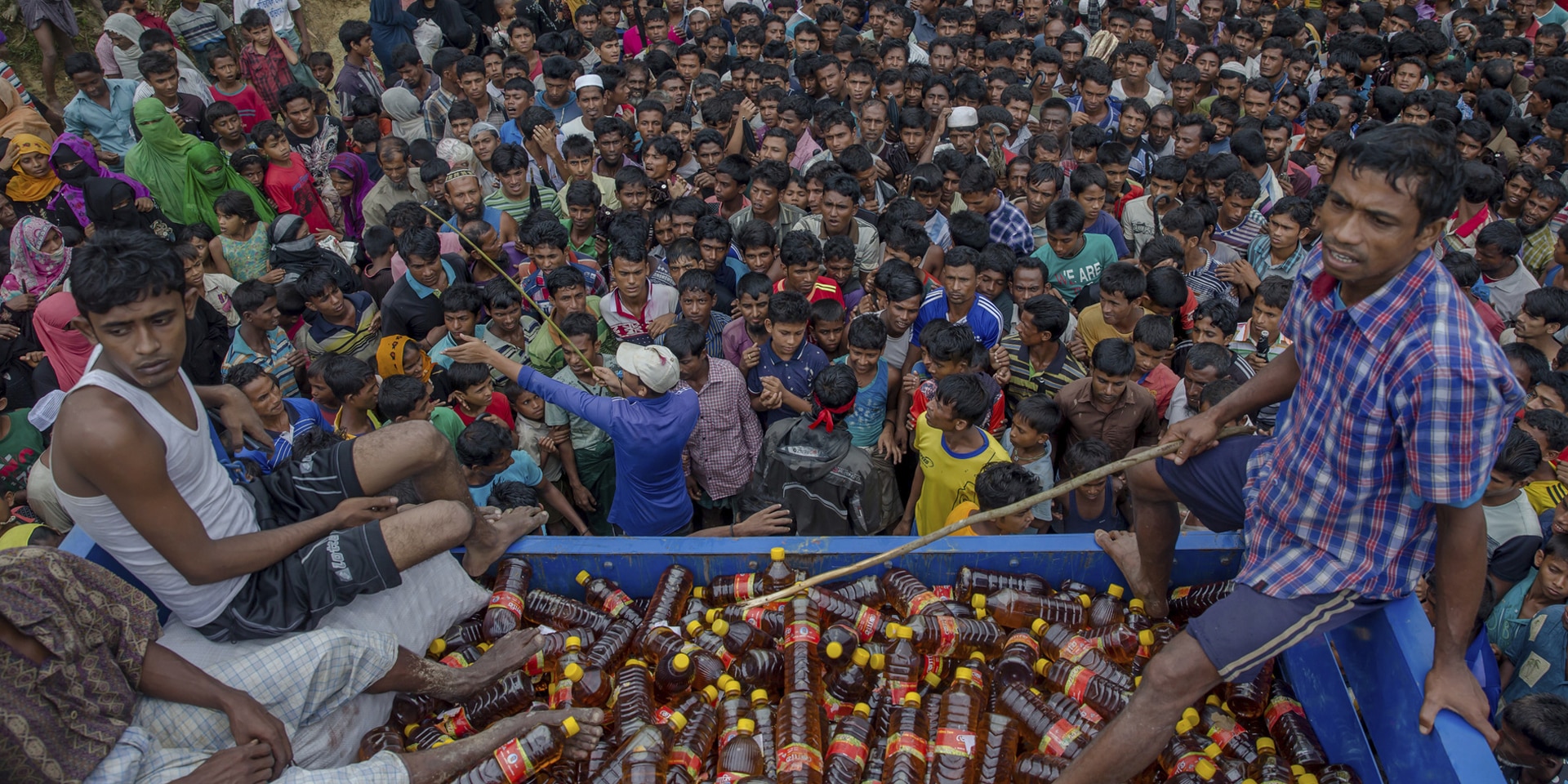  Una folla densa e compatta si stringe attorno a una distribuzione di bevande nel campo profughi di Kutupalong-Balukhali, in Bangladesh.