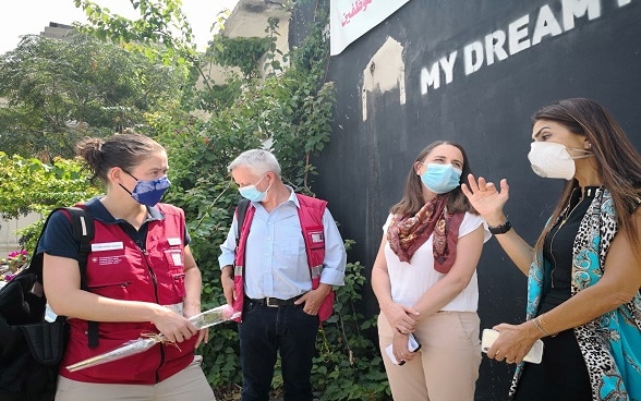 Emilie Schmid conversa con un grupo de personas durante la inauguración de un servicio pediátrico temporal creado por Suiza en Beirut.