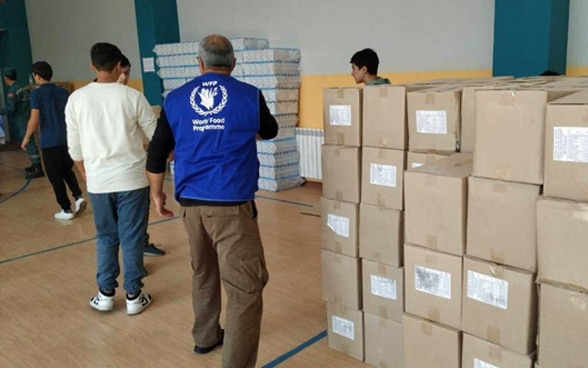 Food distribution is organised in a large hall.