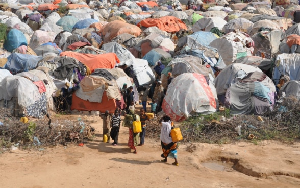 Children entering a camp for displaced people. 