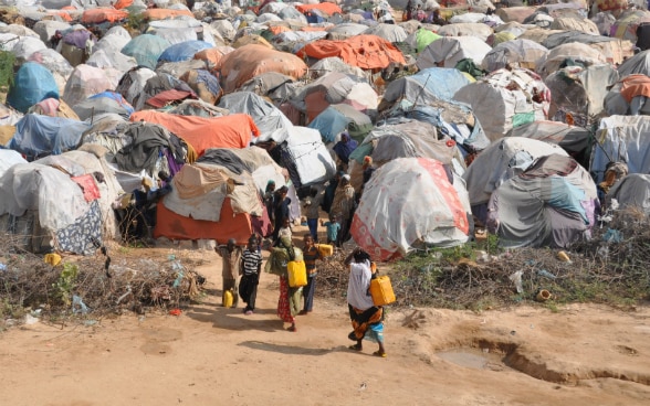 Children entering a camp for displaced people.