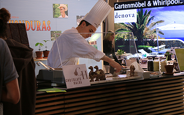 Au stand Honduras de l'exposition spéciale de la DDC à l'OLMA 2015, un pâtissier fait couler du chocolat dans des moules. 