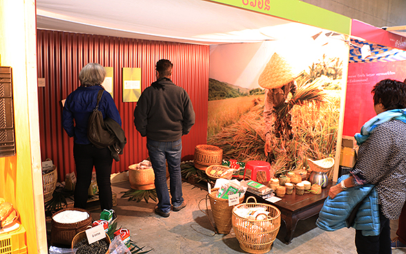 Visitors at the Laos stand in the SDC’s special exhibition at OLMA 2015.