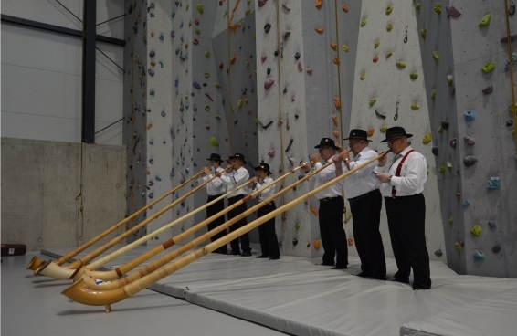 Six Swiss musicians in traditional attire give an alphorn concert in the new climbing gym in the town of Sátoraljaújhely. 
