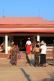 A nurse receives patients at the entrance to a health centre.