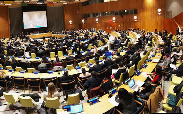 Filled conference hall with representatives from all over the world.