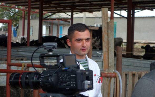 The photo shows Giorgi, a trained veterinary assistant in Dedoplistskaro looking at the cameraman.