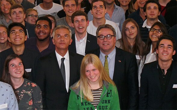 The President of the Swiss Confederation, Didier Burkhalter, standing among participants at the Youth Parliament Conference in Laufen.© FDFA