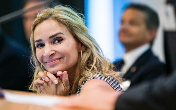 An ambassador of the panel discussion smiles into the camera