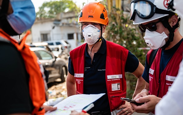 L'ingegnere Regina Wenk parla con due ingegneri del Corpo svizzero di aiuto umanitario.