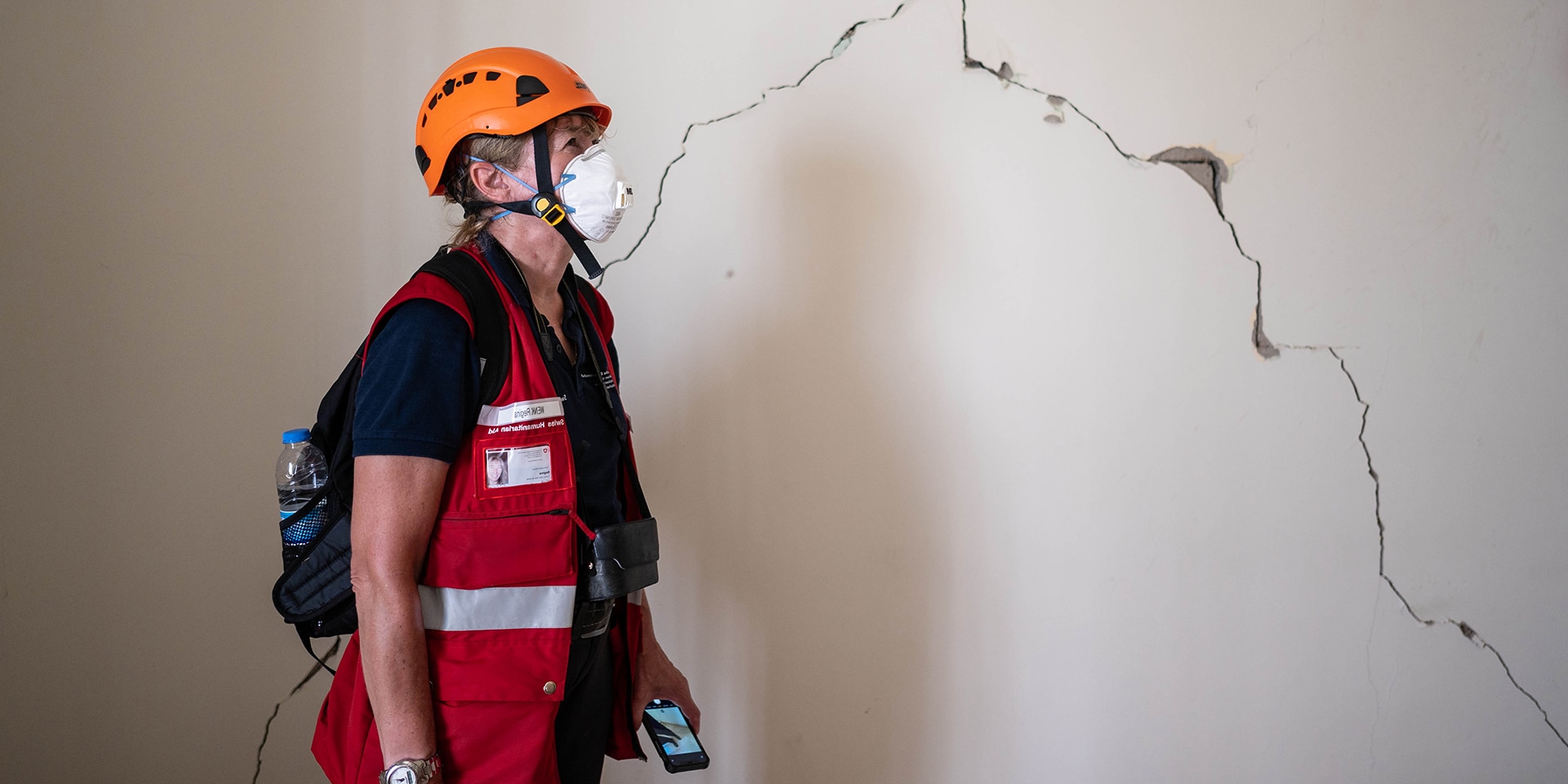 Engineer Regina Wenk examines a damaged wall for its stability.