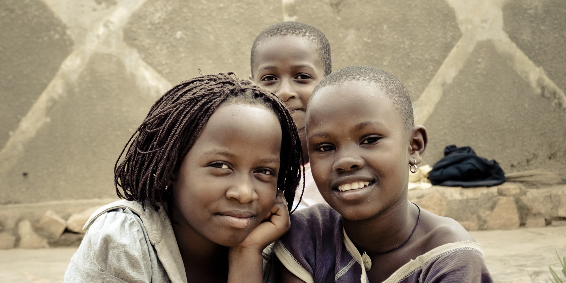 Three street children posing for the camera in Kampala, Uganda.