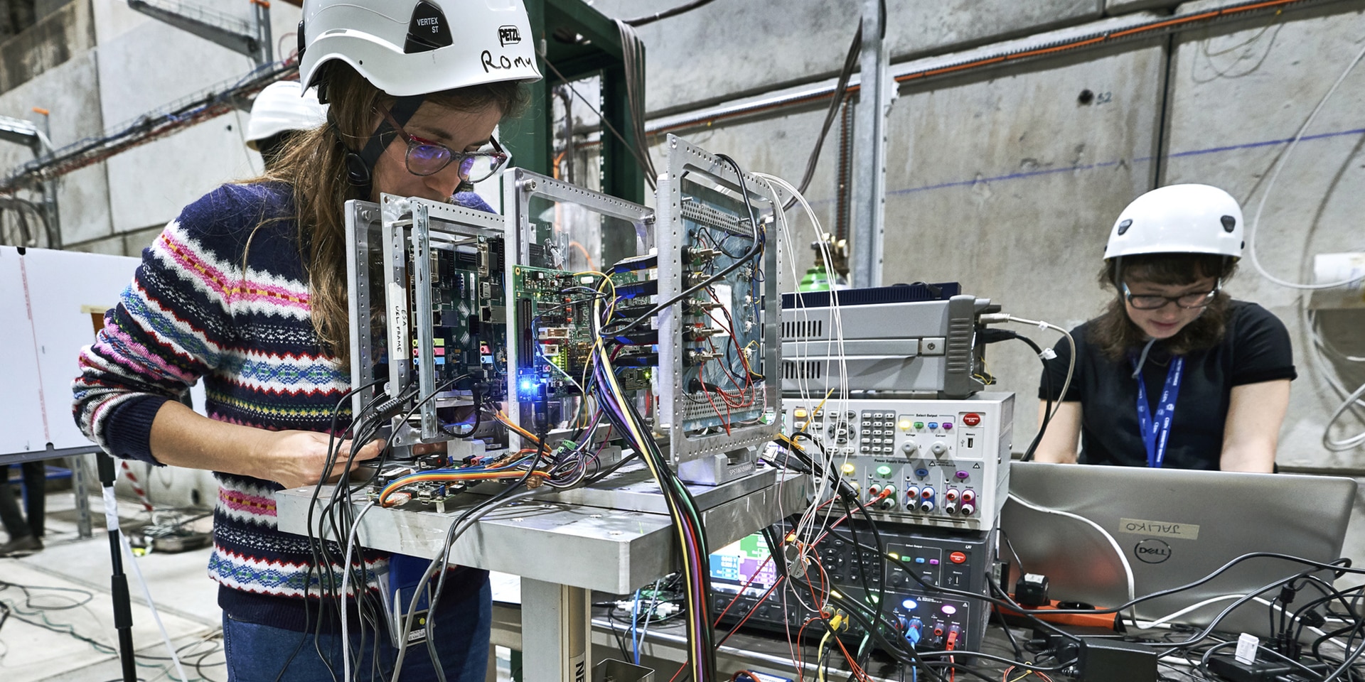 Two women conduct artificial intelligence tests with machines.