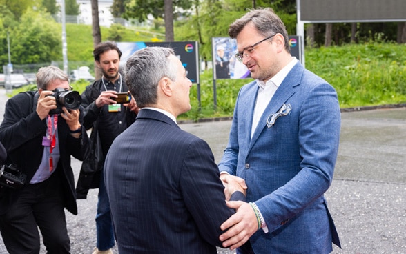 Bundespräsident Cassis und Aussenminister Kuleba begrüssen sich vor dem Gebäude des Kongresszentrums in Davos.