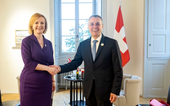 President of the Swiss Confederation Ignazio Cassis shakes hands with UK Foreign Minister Elizabeth Truss at the Villa Ciani in Lugano.
