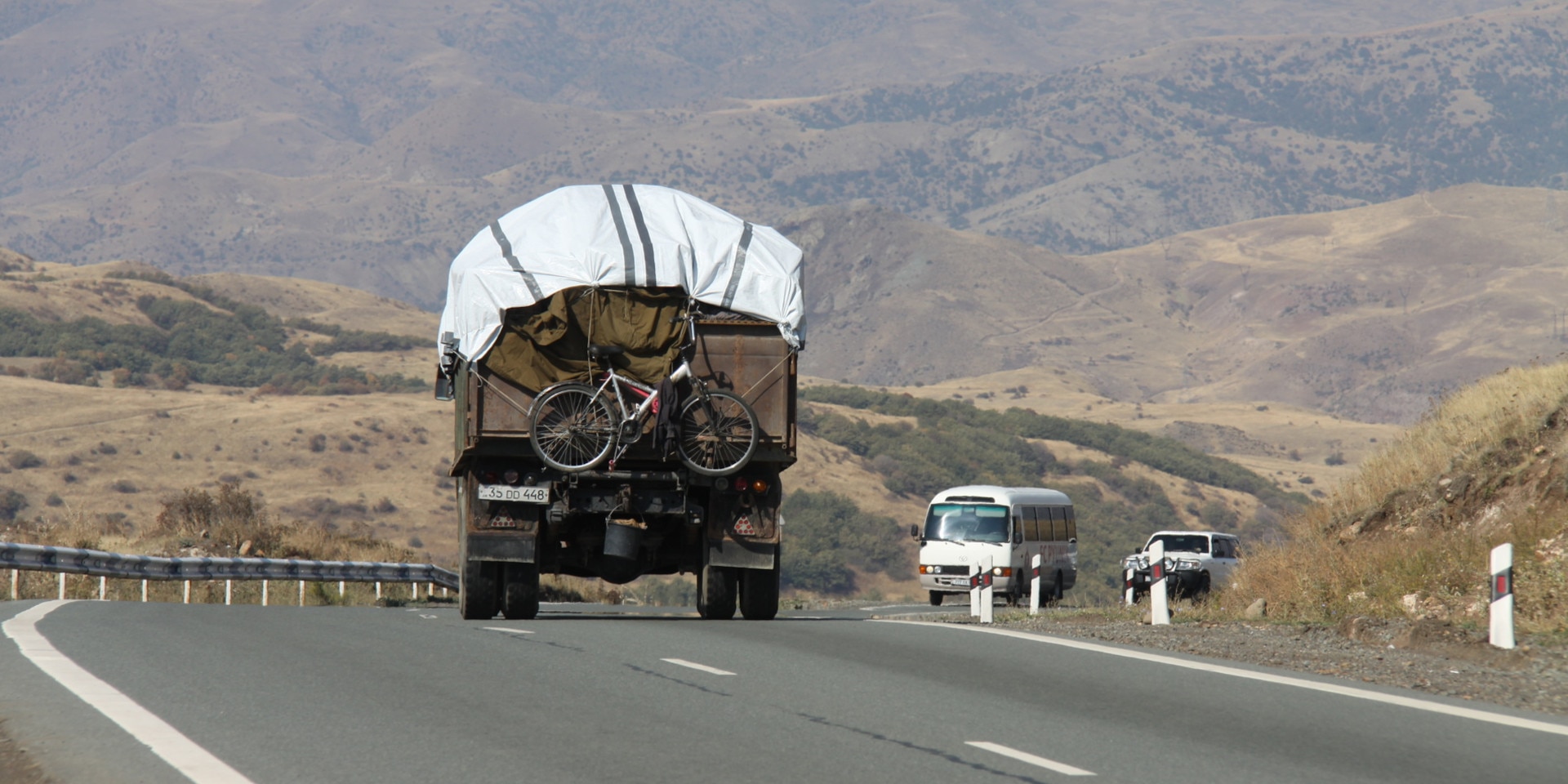 A truck carrying a bicycle drives towards Armenia from Nagorno-Karabakh.