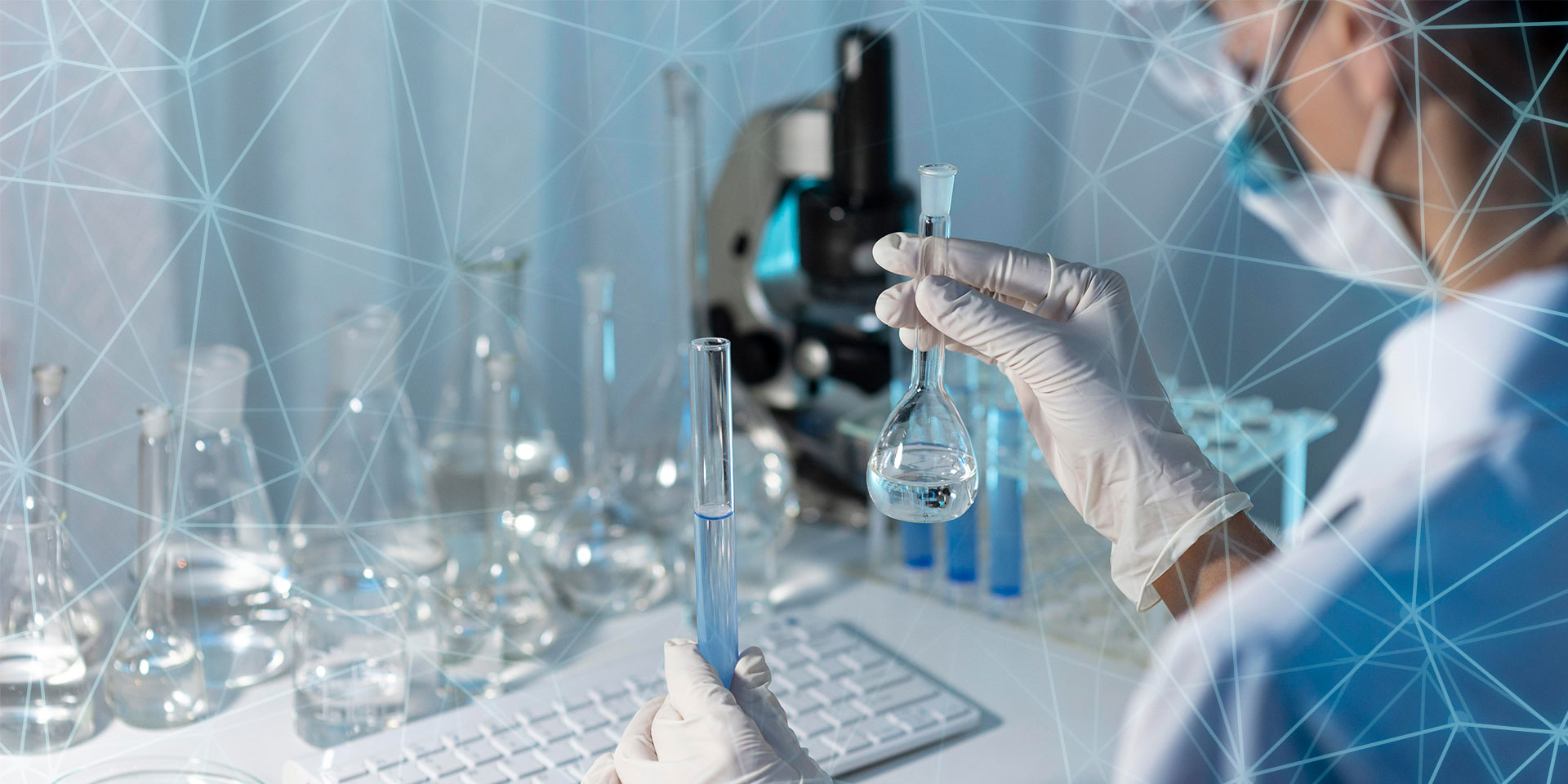  A scientist wearing gloves is holding two test tubes.