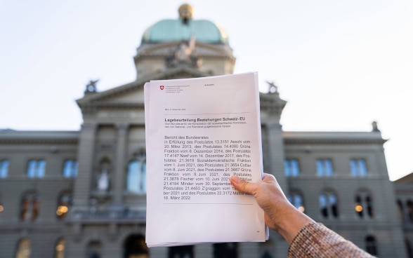  The report’s document with the Federal Palace in the background. 
