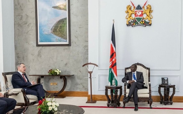 Ignazio Cassis and William Samoei Ruto are seated in armchairs.