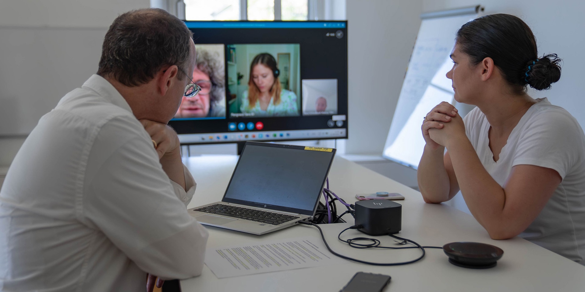 Interview, analog und digital: Gespräch über die Verhandlungen über die UNO-Konvention zur Cyberkriminalität mit Irene Grohsmann (AIS, r.) und Andrea Candrian und Sara Pangrazzi (Bundesamt für Justiz, Bildschirm). 