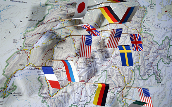 Map of Switzerland with several international flags