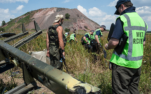 International investigators working around the remains of the Malaysia Airlines' aircraft that crashed in eastern Ukraine in summer 2014