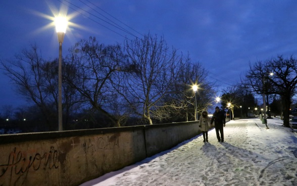 Deux piétons sur un chemin illuminé