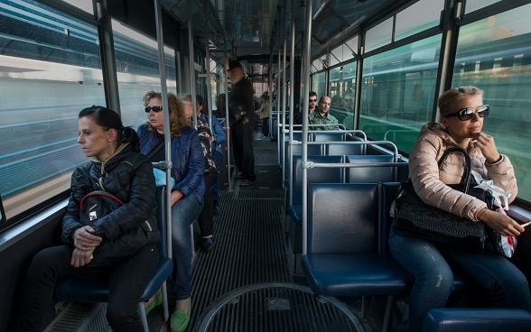 Passengers sitting in a tram.